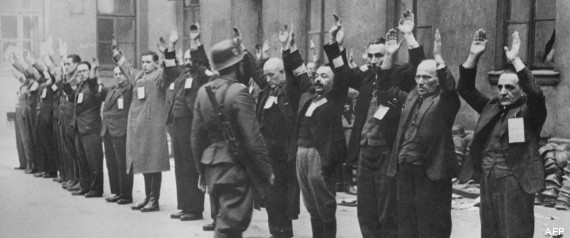 A Nazi SS-man inspects a group of Jewish workers in April 1943 in the Ghetto of Warsaw. In November 1940, the Germans established the Warsaw ghetto. The Jewish population still living outside was brought inside the special area, and the Polish living within the designated ghetto boundaries were ordered to move out. On November 15th no Jew was allowed to leave the Jewish precincts. In the Summer of 1942, about 300,000 Jews were deported to Treblinka. When reports of mass murder in the killing center leaked back to the ghetto, a surviving group of mostly young people formed an organisation called Z.O.B. (Zydowska Organizacja Bojowa, Jewish Fighting Organisation) calling for the Jewish people to resist. On April 19, 1943 the Warsaw ghetto uprising began after German troops and police entered the ghetto to deport its surviving inhabitants. Seven hundred and fifty fighters fought for nearly a month. But on May 16, 1943, the revolt ended The Germans had slowly crushed the resistance. Of the more than 56,000 Jews captured, about 7,000 were shot, and the remainder were deported to killing centers or concentration camps. (FILM)  AFP PHOTO